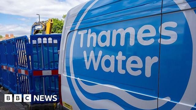 A Thames Water utility van parked on a London street next to construction work