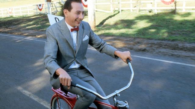 Paul Reubens rides a bike in a scene from the film 'Pee-Wee's Big Adventure', 1985. (Photo by Warner Brothers/Getty Images)