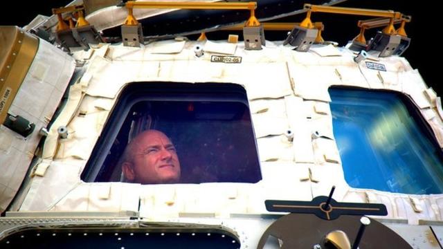In this undated photo provided by NASA on Tuesday, March 1, 2016, astronaut Scott Kelly looks out the cupola of the International Space Station. (NASA via AP, File)