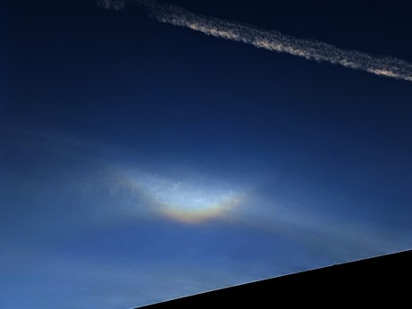 A bright V in the sky, slightly reddish toward the bottom, touching a fainter arc below it.