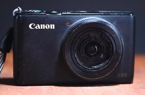 Canon PowerShot S95 10 MP Camera missing the front bezel and lens cap assembly 