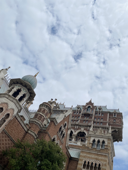 Looking up the castle buildings in front of the cloudy sky at Disney Sea 