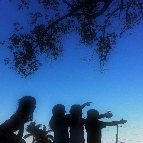 Four shadows of the girls in blue sky