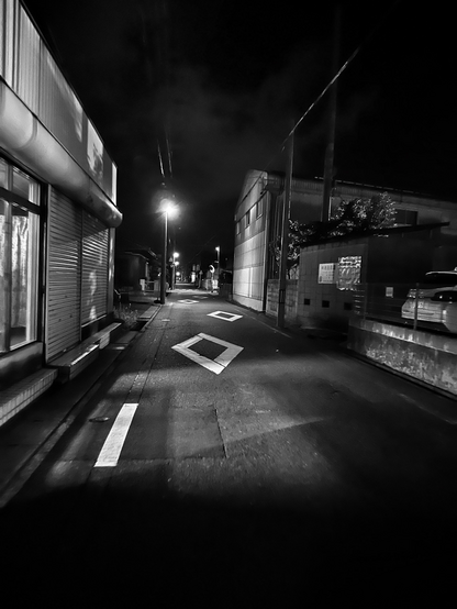 There’re houses, street lights, and parking along the narrow street