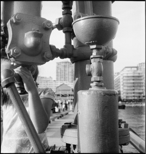 A kid plays on equipment on the pier.