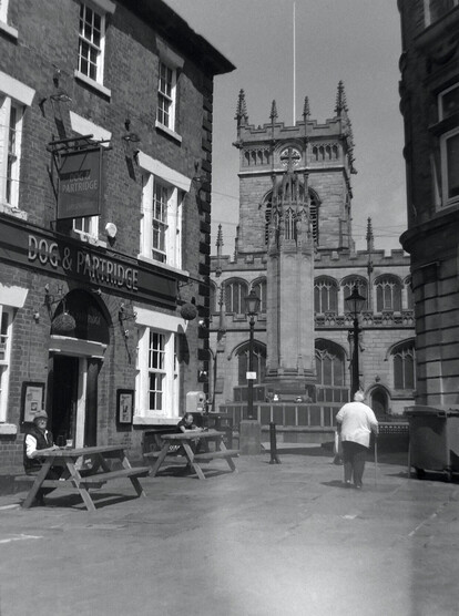 A 6x4.5 120 medium format black and white film photo of the pathway to the Cenotaph and Wigan Parish Church