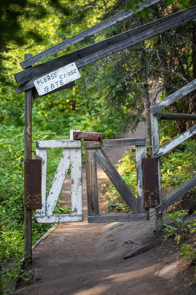 A wooden gate on a walking path