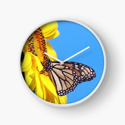 Monarch Butterfly and yellow sunflower with blue sky wall clock