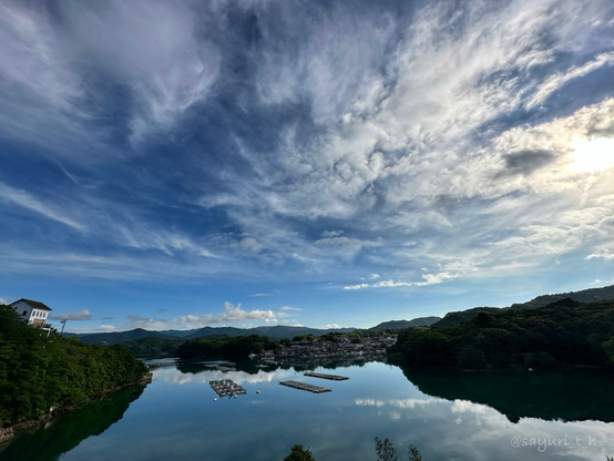 Early morning sky with bright blue sky and still dark ocean