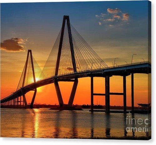 This is a gorgeous sunset over the Arthur J. Ravenel Bridge at Charleston, South Carolina. The skies are blue and gold and orange behind the bridge, and the sunset casts a beautiful reflection on the Cooper River. This artwork is from the Fine Art Gallery of Shelia Hunt.
