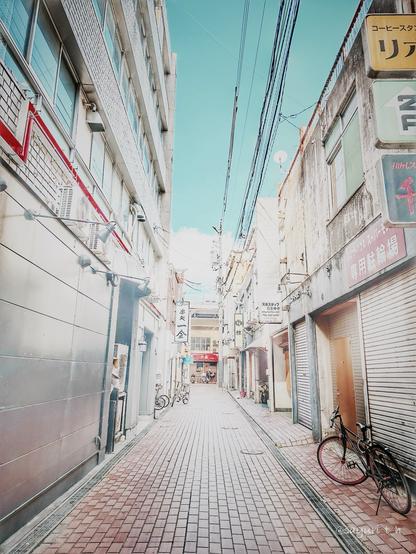 Narrow tiled backstreet in between buildings
