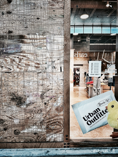 Scratched wood on wall and glass window that you can see inside of the shop