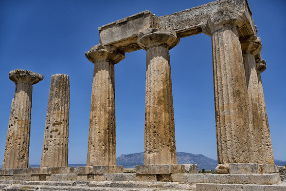 The Temple of Apollo in ancient Corinth, Greece.

Built around 560 B.C.E. atop a rocky hill, the Temple of Apollo is one of the earliest Doric temples in Greece. It was restored In the Roman period and dedicated to the cult of the Emperor. In the Byzantine era was turned into a basilica, whereas in the Ottoman period was partly demolished and a new residence of the local Turkish Bey was built on top of its crepis. Today only seven standing columns are preserved.