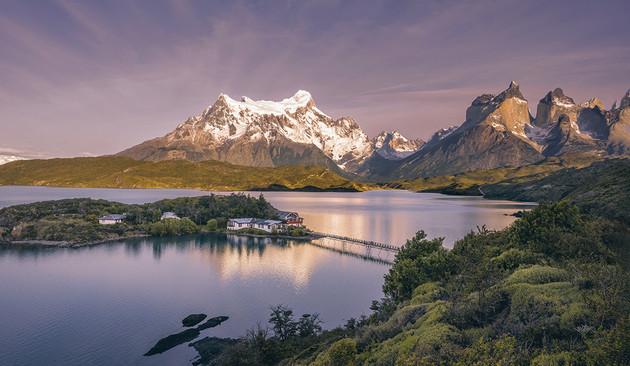 One of the most delightful of our accommodations in Patagonia was the Hosteria Pehoe, situated on an island in Lake Pehoe in Torres del Paine National Park (Chile). From these lodgings we could see the snow-capped mountains towering majestically over the scene and reflecting in the tranquil lake below. A wooden walkway connects the island to a parking area.
