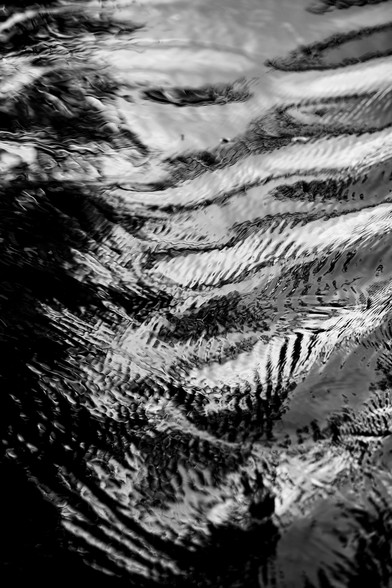 Black and white close-up texture of rippling water.