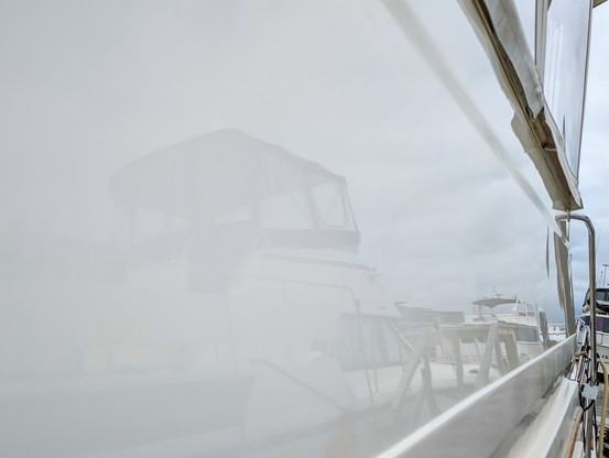 Recently polished section of aft deck is white and reflects Hatteras next to it.