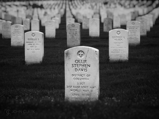 Black and white picture of gravestones in alignment at Arlington National Cemetery 