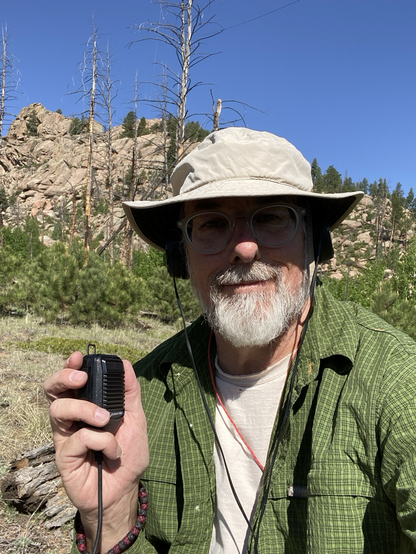 Smiling ham radio operator in the mountains 
