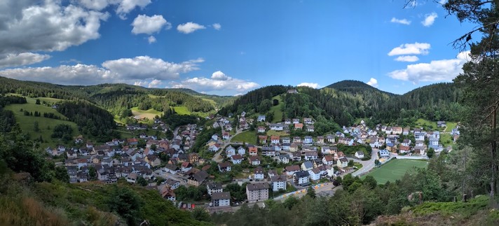 View of Lauterbach from a viewpoint not on the marked trail on AllTrails that I found off of another map. Beautiful blue sky and puffy white clouds with town surrounded by green hills