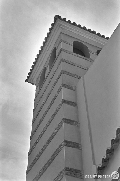 A black-and-white film photo of the Monasterio belfry. 