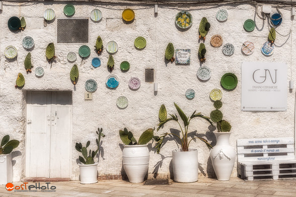 Colored ceramic plates on a white wall in Grottaglie in Italy's Puglia