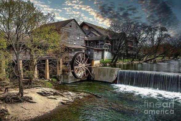 Historic Old Mill at Pigeon Forge in the Great Smoky Mountains, East Tennessee, framed by rolling hills and natural beauty; a rustic mill built in 1830 still powered by water to grind flour and meal, evoking Southern heritage and pioneer resilience. From the Fine Art Gallery of Shelia Hunt.