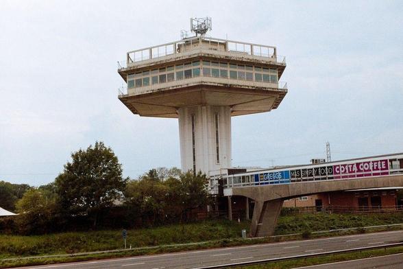 motorway with bridge to other side, the service station there has a large tower
