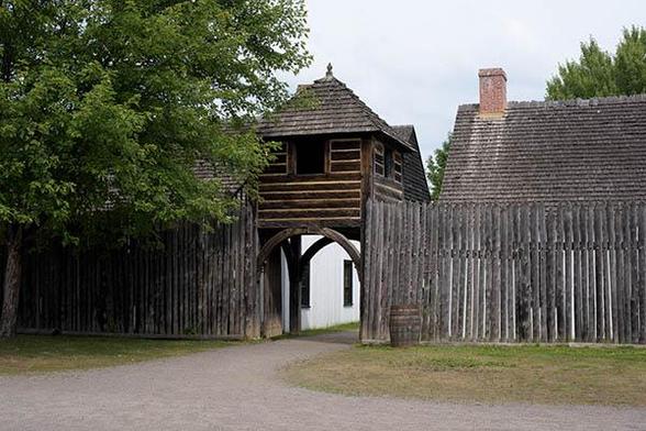 The entrace is just below the middle of the photo.
It is a tower flanke by a wooden wall.