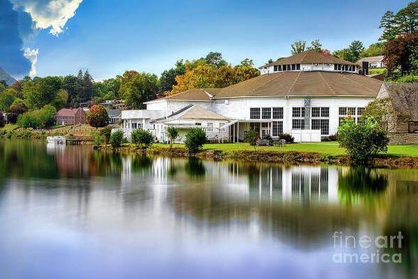 Reflection of Stuart Auditorium on the calm waters of Lake Junaluska in the Blue Ridge Mountains of North Carolina, showcasing the natural beauty and resilience of the Appalachian region following the impact of Hurricane Helene in September 2024.  From the Fine Art Gallery of Shelia Hunt.