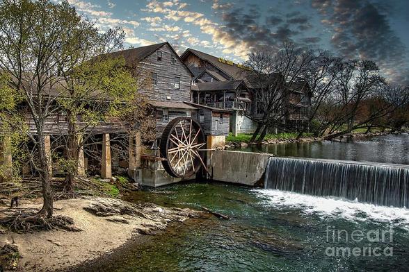Historic Old Mill at Pigeon Forge in the Great Smoky Mountains, East Tennessee, framed by rolling hills and natural beauty; a rustic mill built in 1830 still powered by water to grind flour and meal, evoking Southern heritage and pioneer resilience. From the Fine Art Gallery of Shelia Hunt.