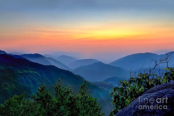 A stunning sunset with beautiful hues of pink, orange and yellow appeared over the beautiful blue ridges of the Great Smoky Mountains National Park of East Tennessee. Image by Shelia Hunt Photography.
