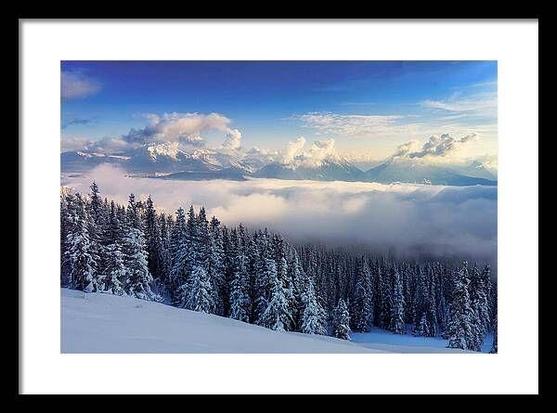 Winter snow scene in the Blue Ridge Mountains of North Carolina, featuring snow-covered peaks and valleys under a deep blue sky. Soft puff clouds and fog linger around the mountains, with sunlight illuminating the peaks. Taken near Mount Mitchell, just off the Blue Ridge Parkway, this tranquil winter landscape captures the essence of North Carolina's mountain beauty.   From the Fine Art Gallery of Shelia Hunt at Shelia-Hunt.pixels.com