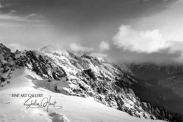 Black and white winter scene of snowy ridges, misty fog, and clouds in the Blue Ridge Mountains of Western North Carolina near Grandfather Mountain.  From the Fine Art Gallery of Shelia Hunt at Shelia-Hunt.pixels.com