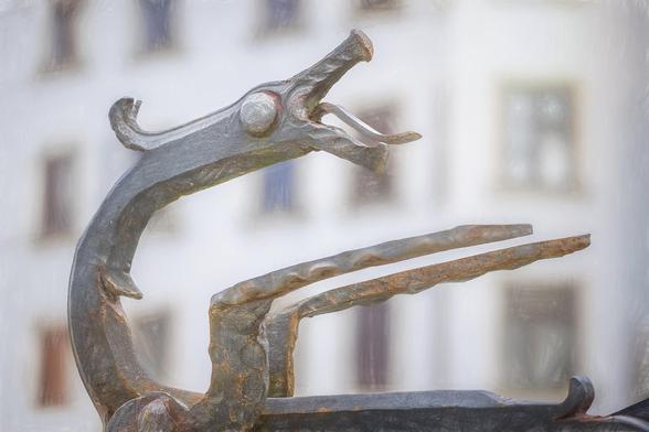 A modern stylized sculpture of a dragon seen in Ljubljana Slovenia. This sculpture is prominently displayed with open mouth and detailed texture on a riverside wall. The background is softly blurred, highlighting the sculpture's features and creating a sense of depth. The whole is processed with artistic textures.

https://joan-carroll.pixels.com/featured/stylized-dragon-ljubljana-slovenia-joan-carroll.html

#dragon #stylized #modern #slovenia #ljubljana #modern #sculpture #mythical #travel #travelphotography #textures #artistic #metal #creature #abstract #AYearForArt #buyIntoArt #giftideas #wallart #artforsale @joancarroll 