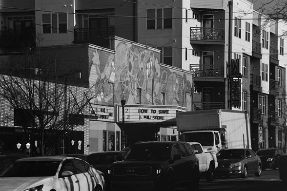 An old theater with “how to save a milestone” on the marquee