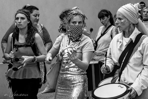 Women carrying various percussion instruments support the demonstration on March 8.