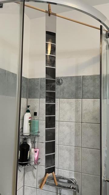 Black and white film type 120 is hanging in the shower box