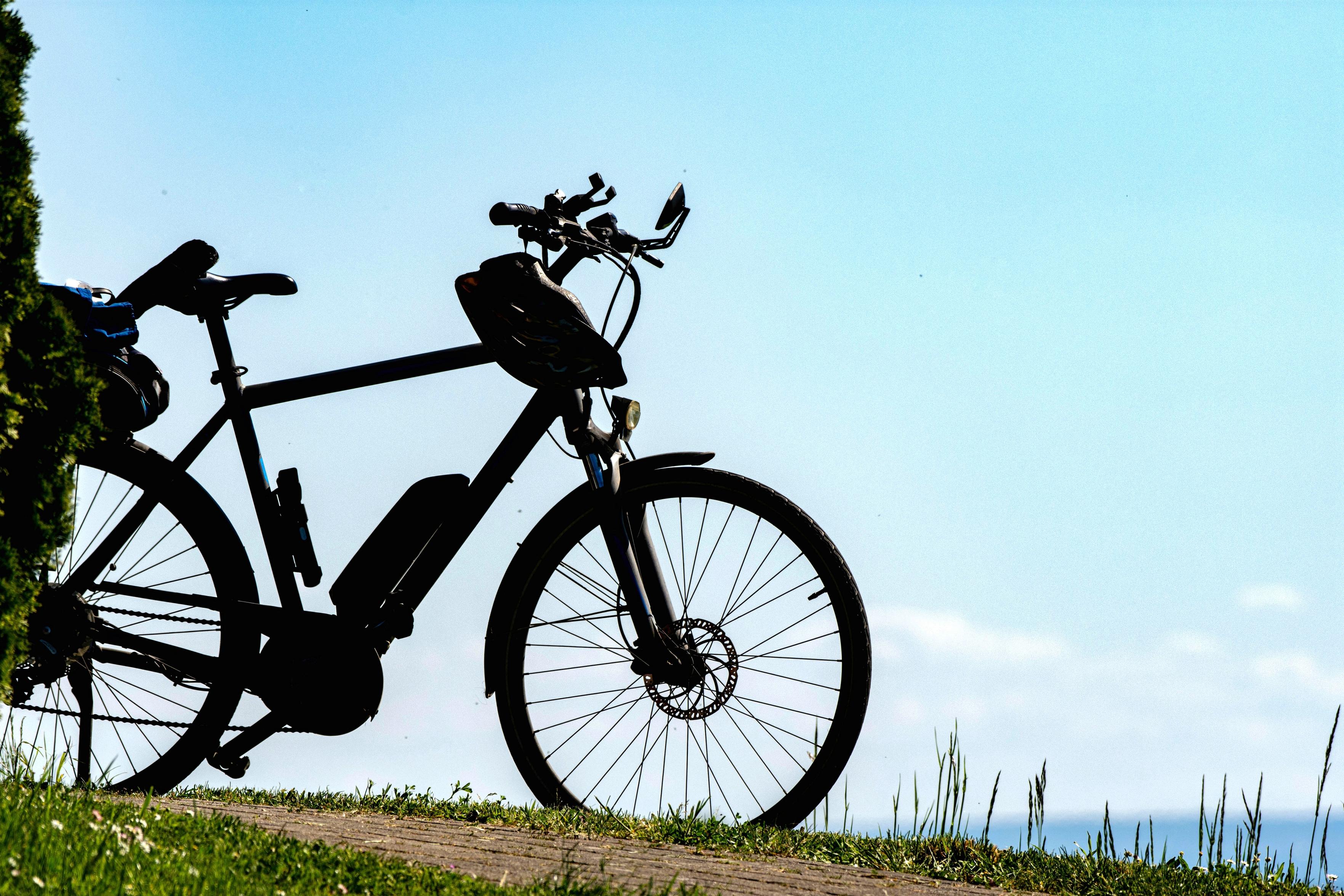 Die Silhouette eines Fahrrad vor blauen Himmel. 