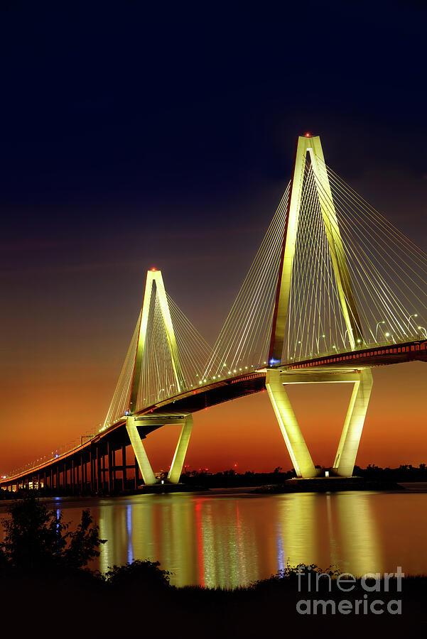 Arthur J. Ravenel Jr. Bridge, glowing with lights just after sunset with a stunning reflection in the Cooper River. Locals call it the Cooper River Bridge. From the Fine Art Gallery of Shelia Hunt.