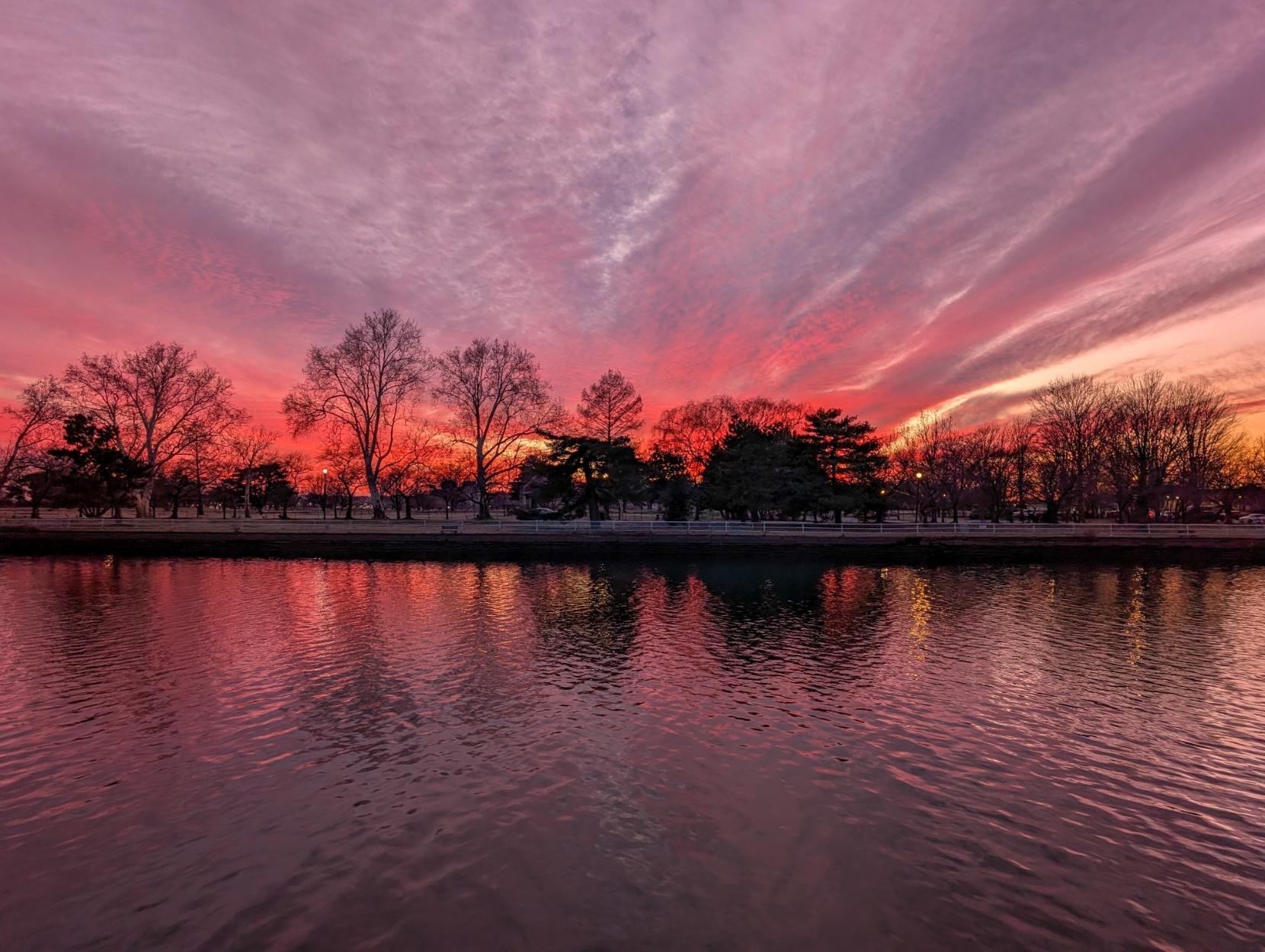 Pink and purple haze of low clouds at dusk reflecting on the Washington Channel