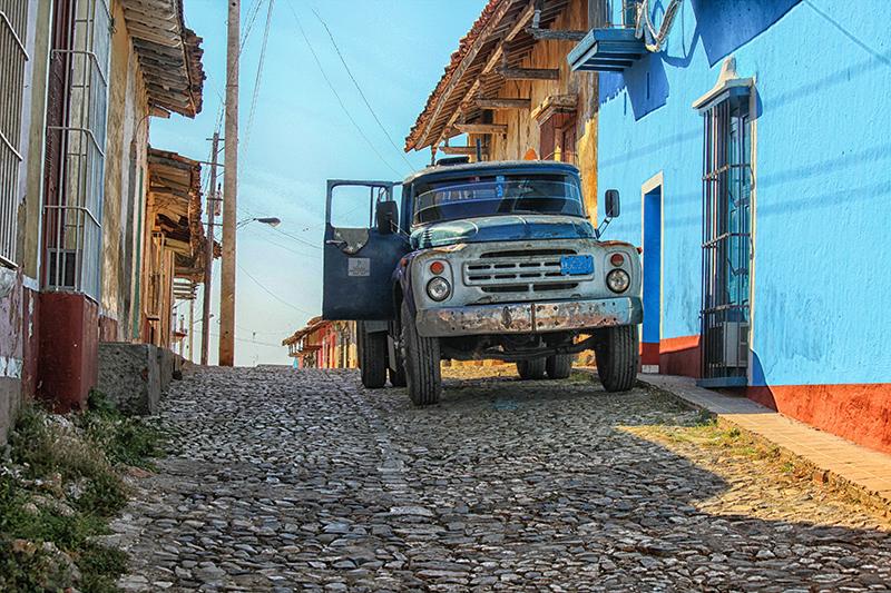 Old blue truck on a cobblestone street in Trinidad, Cuba