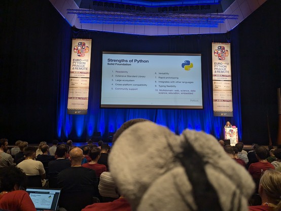 Plush donkey looking at keynote presentation by Carol Willing at EuroPython 