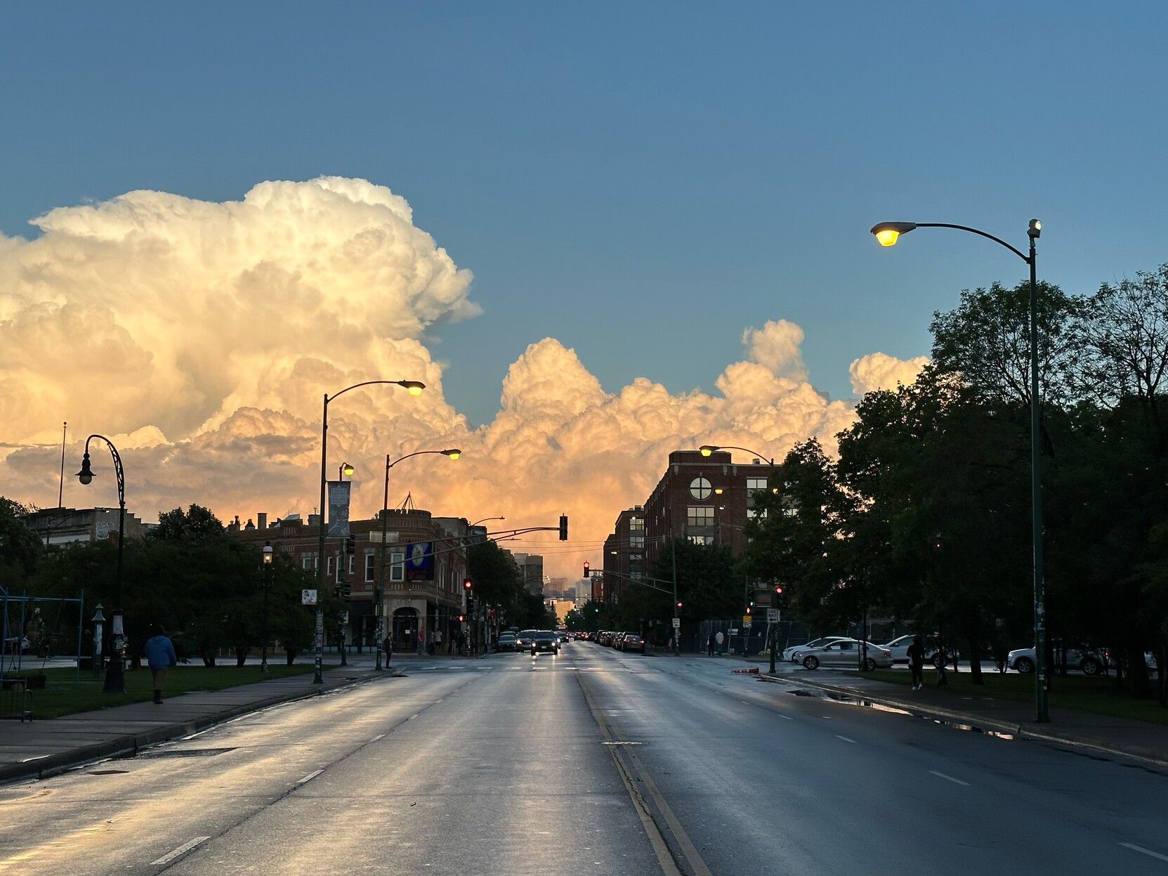 A view straight down Milwaukee avenue with gorgeous orange storm clouds rippling across the sky 