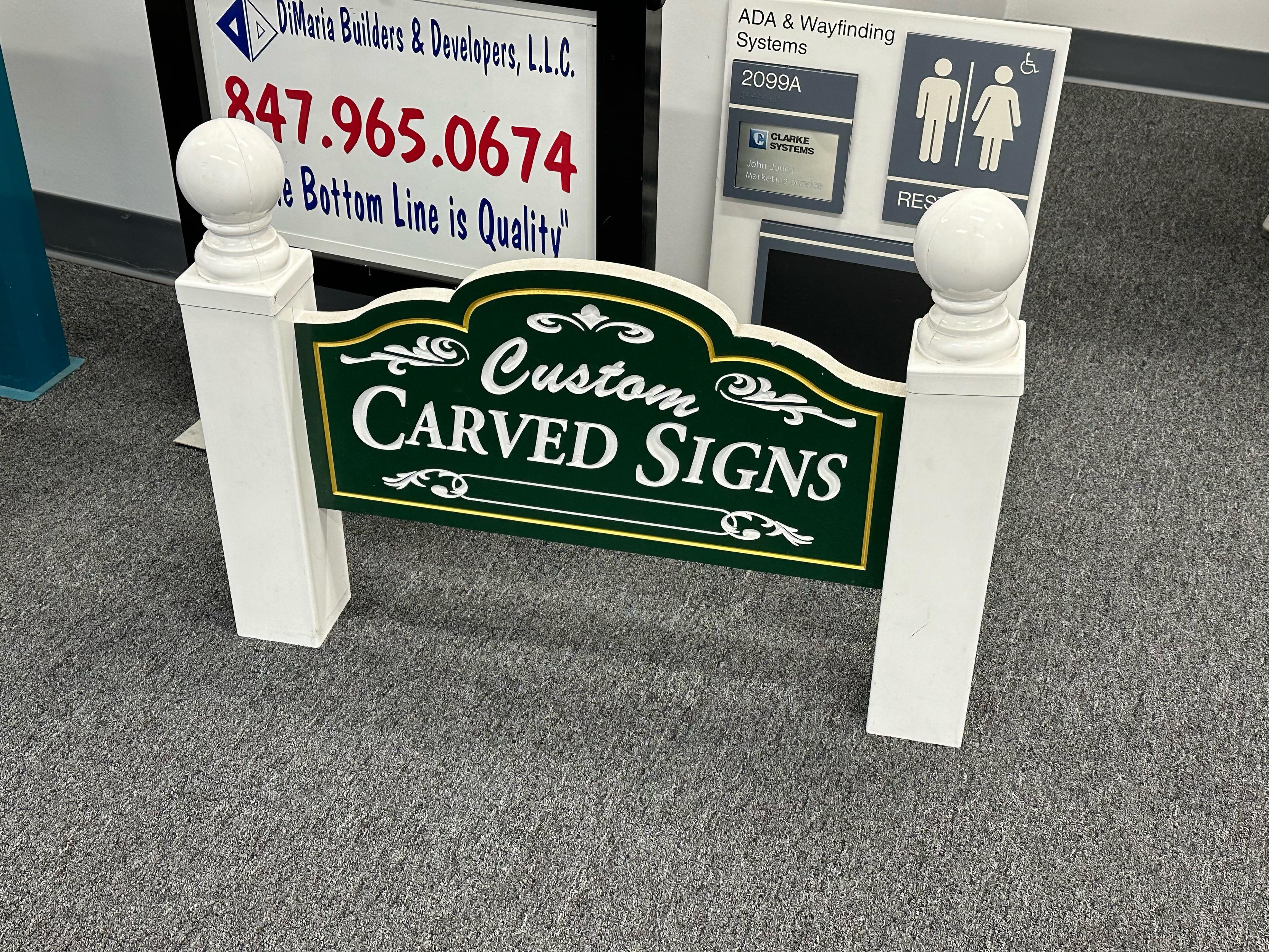 A little sign that says “custom carved signs”