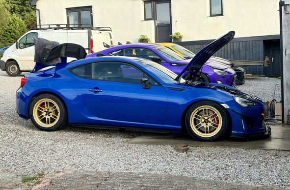 Freshly washed Subaru BRZ track car being checked and loaded