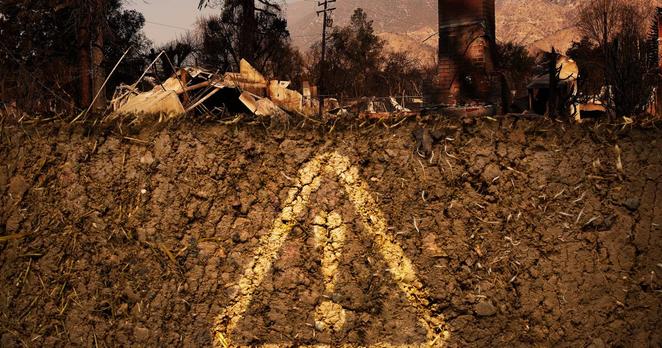 Photo illustration of an alarm signal in a cross section of soil under a burned property.