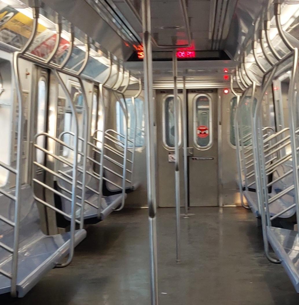 New York Subway S train showing the current time on its informational display