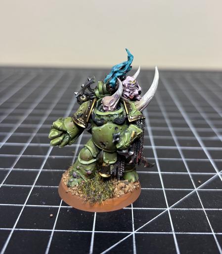A miniature of a plague marine from Warhammer 40k