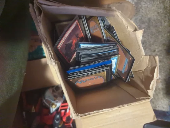 A broken cardboard box full of Magic the Gather cards