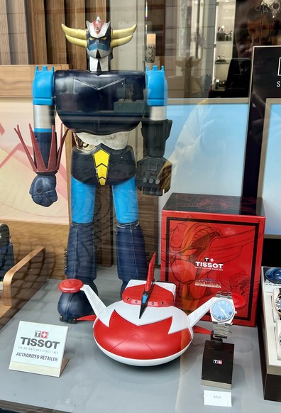 Watch shop display with a big statue of the super robot Grendizer